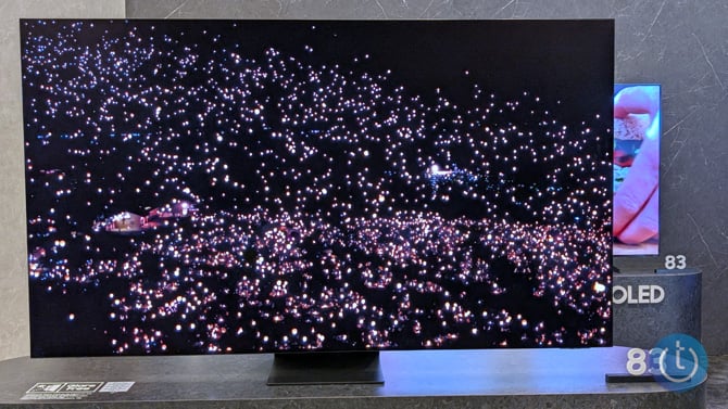 The Samsung S96F OLED TV shows a night sky on the screen.