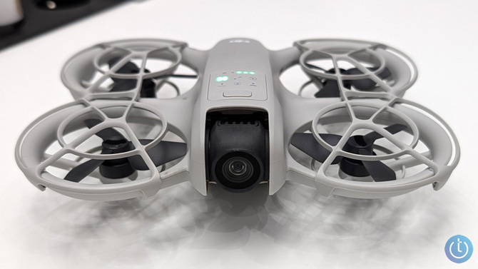 The DJI Neo is shown on a table so you can see the camera in the front.