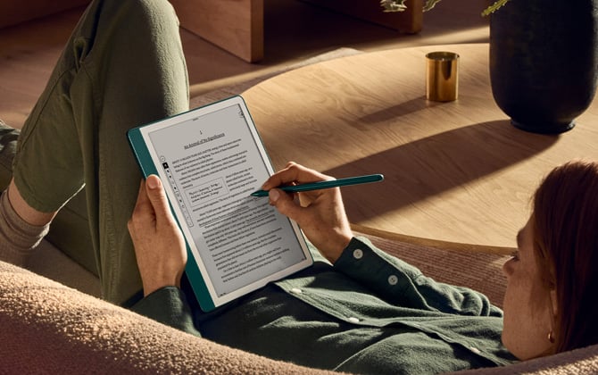 Kindle Scribe with a person writing notes.