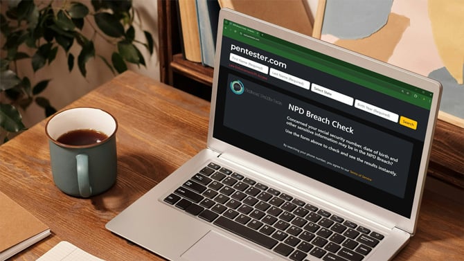 Laptop shows a screenshot of the Penster NPD breach search webpage.