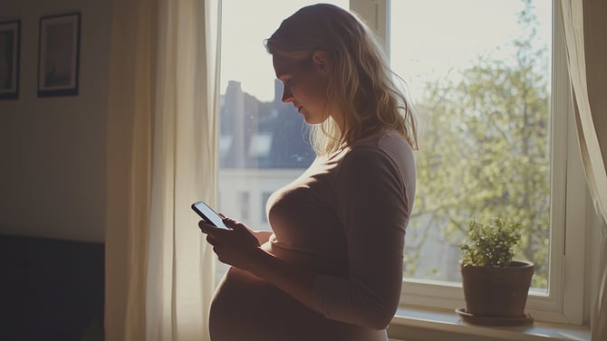 Concept art of a pregnant woman looking at a phone.