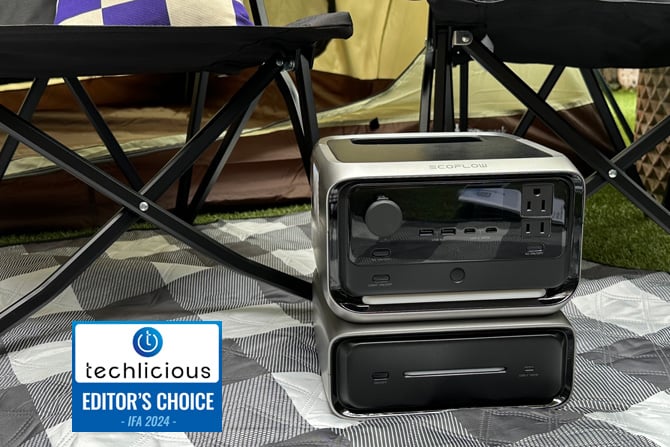 The EcoFlow River 3 Max is shown on a picnic blanket with its extra battery.  The Techlicious Editor's Choice Award logo is in the lower left.