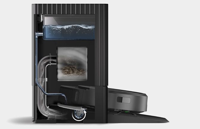 A cutaway diagram of the dock for the Roomba Combo 10 Max. You can see clean water entering the base of the dock where brushes scrub the mop pads. The dirty water is being sucked into a dirty water container in the base.  