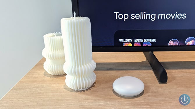 Google Nest Learning Thermostat 4th Gen temperature sensor is shown next to candles.