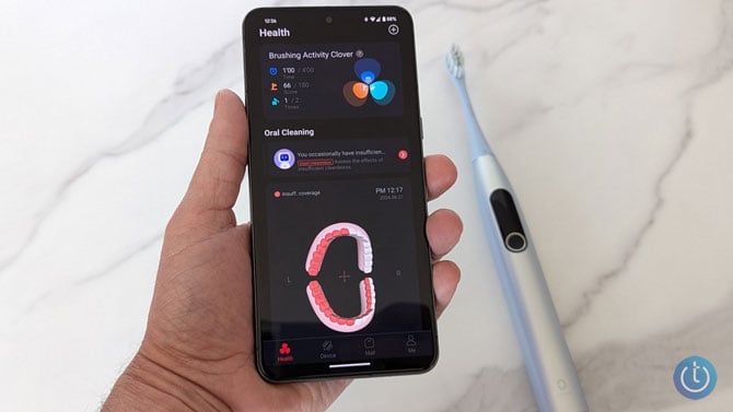 Oclean app showing brushing results. You can see the Oclean X Pro Digital in the background.