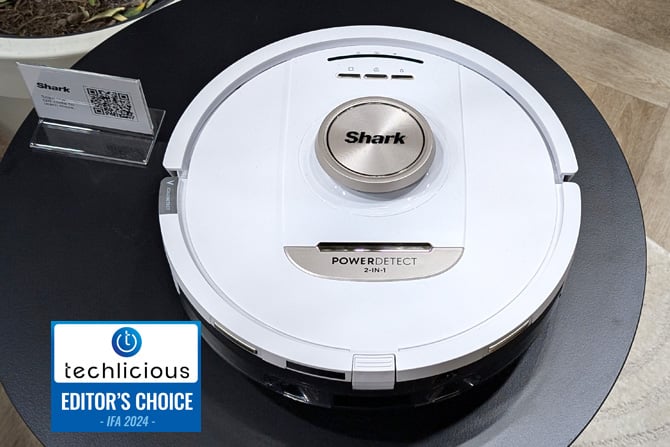  The Shark PowerDetect NeverTouch Pro 2-in-1 Robot Vacuum and Mop is shown from the top.The Techlicious Editor's Choice Award logo is in the lower left.