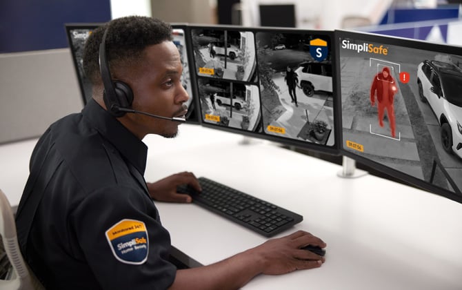 An Active Guard security agent at his monitoring station. You can see a video screen where a person is indicated in red as a potential threat.