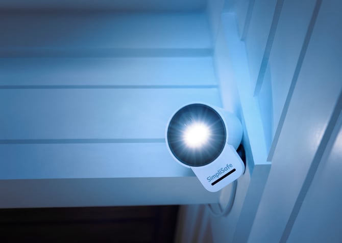 The SimpliSafe Outdoor Security Camera Series 2 is shown mounted outdoors.