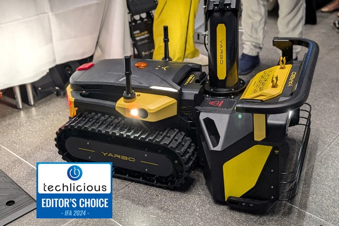  The Yarbo is shown from the side with the snowblower attachment. The Techlicious Editor's Choice Award logo is in the lower left.