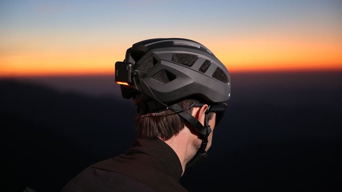 BleeqUp Ranger battery pack mounted to the back of a helmet with the light on. 