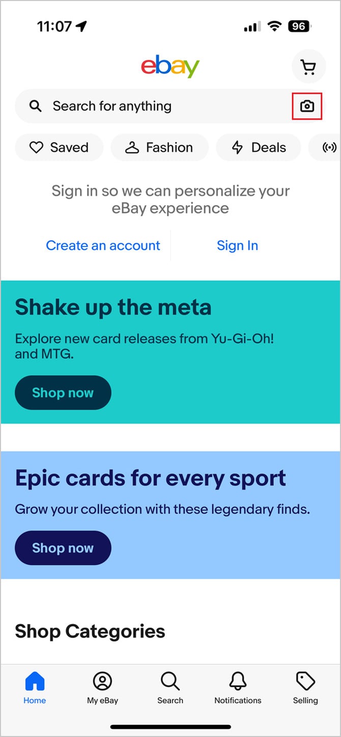 Ebay app screenshot shows the home page of the eBay app with the camera icon outlined in red.