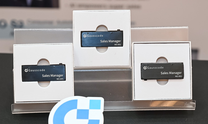 Gausscode badges shown on a display stand.