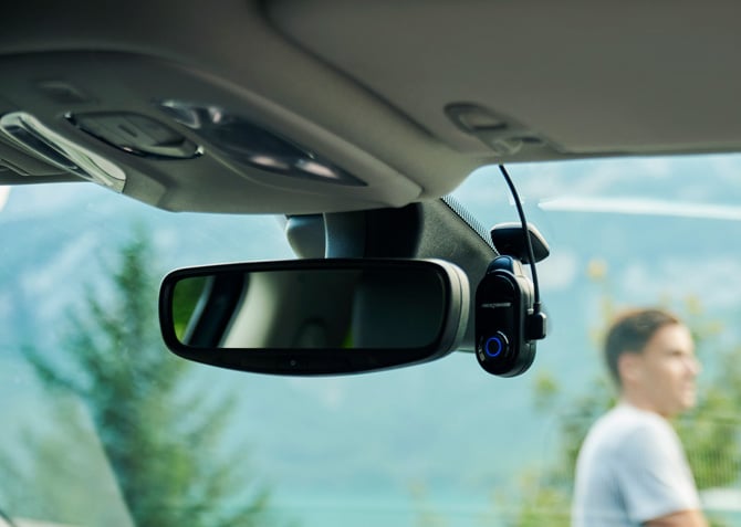 Nextbase Piqo installed next to car rearview mirror