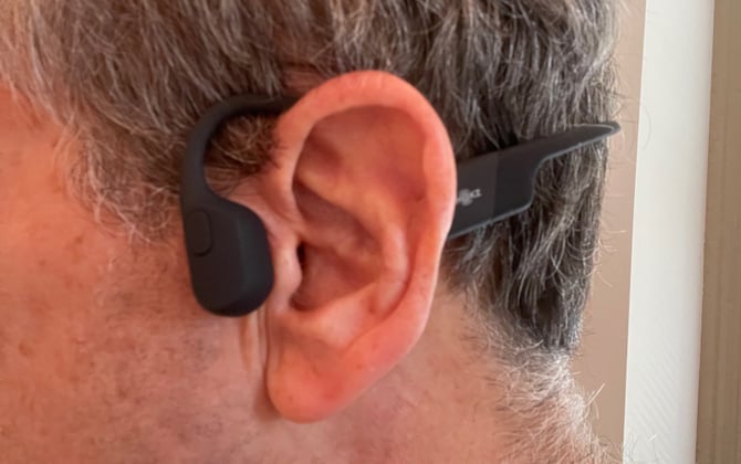 Close-up side view of AfterShokz Aeropex on a model. 