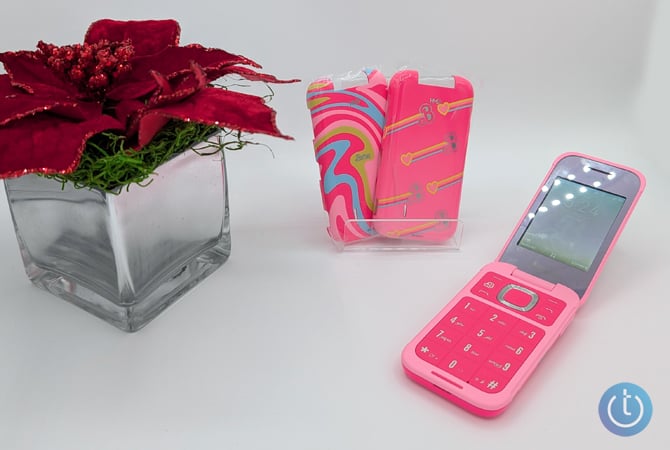 The Barbie Phone is show with two covers and a pointsetta.