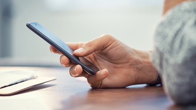 Closeup shot of a hand holding a smartphone.