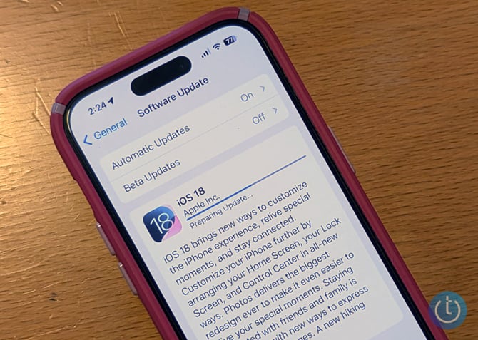 An iPhone shows the upgrade screen for iOS 18