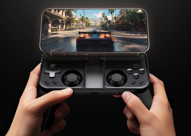 ohsnap MCON held in a person's hand with an iPhone displaying a racing game