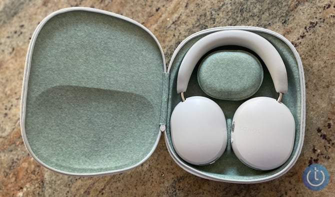 Sonos Ace show inside their case with the accessoy pod nestled in the headphone band.