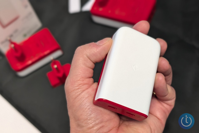 The Twelve South 50W charger is shown from the top in a hand.